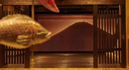 a fish in a cage with a ball in its mouth at HOTEL CLAD in Fuji