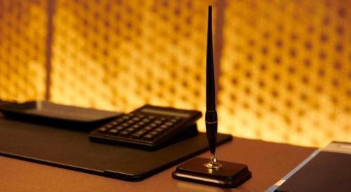 a remote control sitting on top of a desk at HOTEL CLAD in Fuji