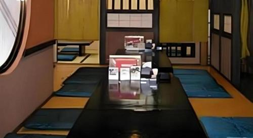 a room with a row of pillows on the floor at Hotel Ito in Wakayama