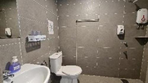 a bathroom with a toilet and a sink at Sg. Paka Hotel in Paka