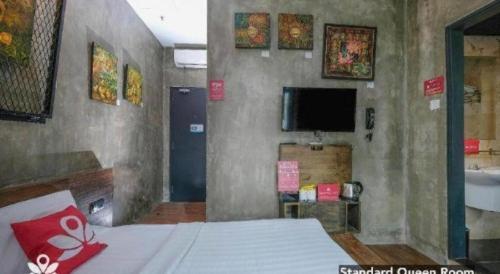 a bedroom with a bed and a tv in a room at The Hulo Hotel & Gallery in Kuala Lumpur