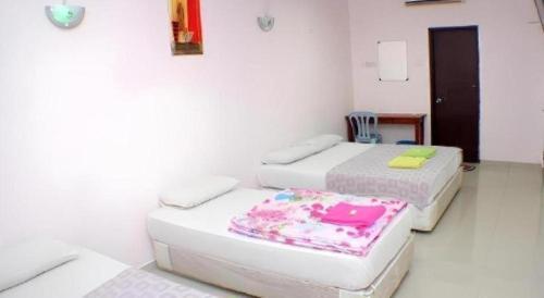 Ένα ή περισσότερα κρεβάτια σε δωμάτιο στο Taipann Hotel