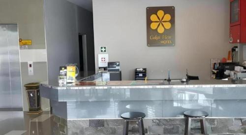 a counter with two bar stools in a restaurant at Cukai View Hotel in Cukai