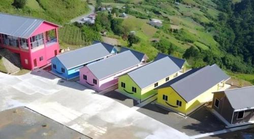 a group of colorful buildings sitting in a parking lot at Happy Village Kundasang in Ranau