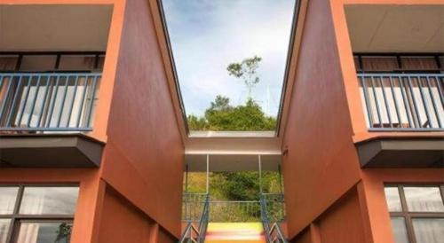 an orange building with a window in the middle at Happy Village Kundasang in Ranau