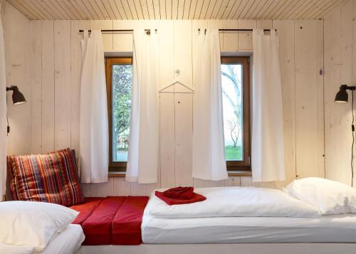 a bedroom with two beds and two windows at Bahnwärterhaus in Droßdorf
