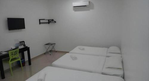 Katil atau katil-katil dalam bilik di Hotel Seri Geliga