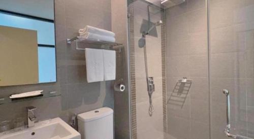 a bathroom with a shower and a toilet and a sink at S Hotel in Johor Bahru