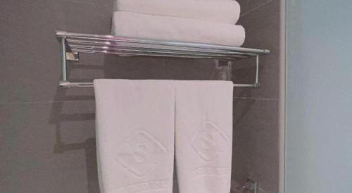 a towel rack in a bathroom with towels at S Hotel in Johor Bahru