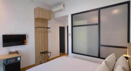 a bedroom with a bed and a large window at S Hotel in Johor Bahru