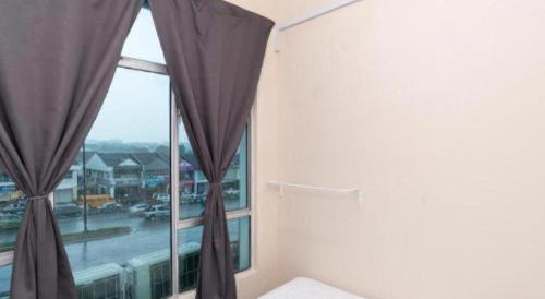 a bedroom with a large window with curtains at SPOT ON 89757 The Rooms JB in Johor Bahru