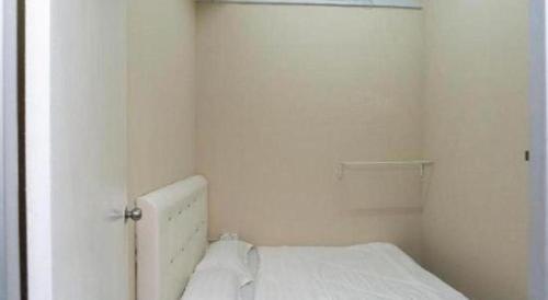 a white bedroom with a bed and a closet at SPOT ON 89757 The Rooms JB in Johor Bahru