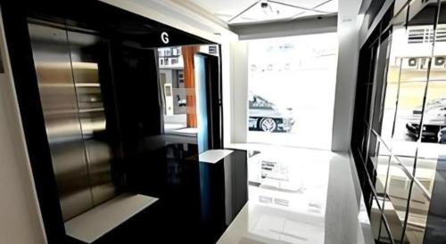 a view of a train door with a car in a window at Eminent Hotel in Kota Kinabalu
