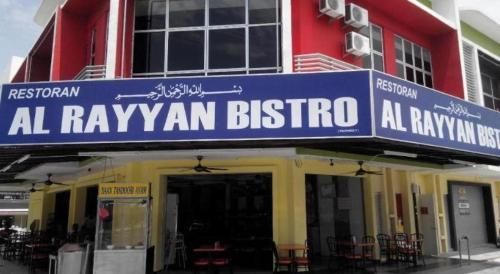 a building with a sign that reads al rayyan bistro at Hotel Zamburger Enstek in Sepang