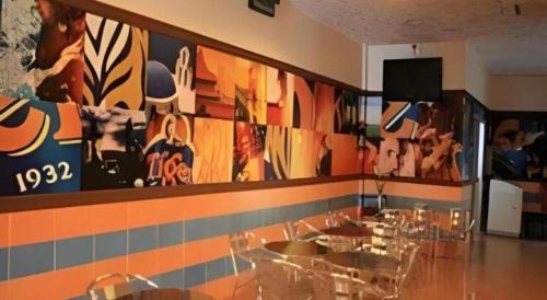 a restaurant with a wall with a mural of animals at Rafayeh Hotel in Seremban
