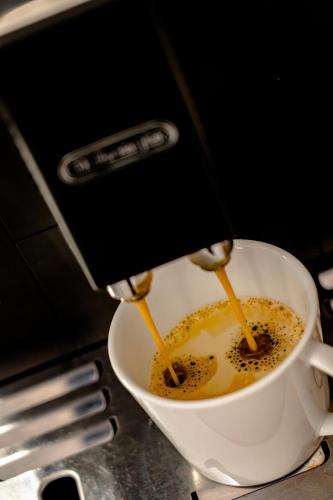 a coffee maker is making a cup of coffee at Apartmány Vera in Bešeňová