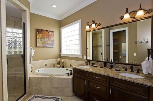 a bathroom with a tub and two sinks and a shower at Orlando Family Friendly Home in Kissimmee