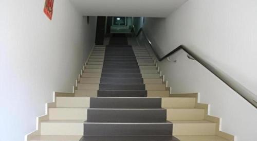 a staircase in a building with grey and white stairs at Rafayeh Hotel in Seremban