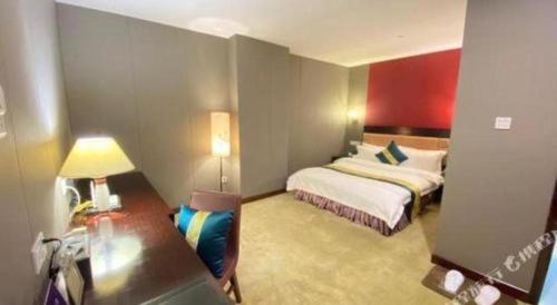 a hotel room with a bed and a desk at Shunde Emperor Hotel in Shunde