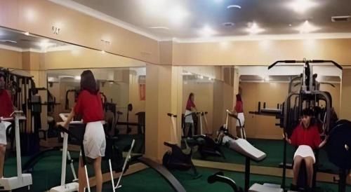 a group of people exercising in a gym at Quanzhou Overseas Chinese Hotel in Quanzhou