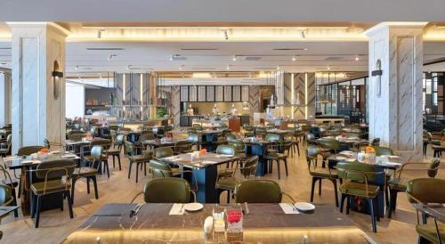 a restaurant with tables and chairs in a room at Hatten Place Melaka in Melaka