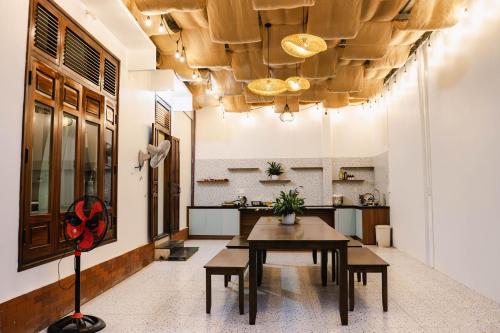 a dining room with a table and a kitchen at Villa Doc Let - Your Home in Doc Let in Nha Trang
