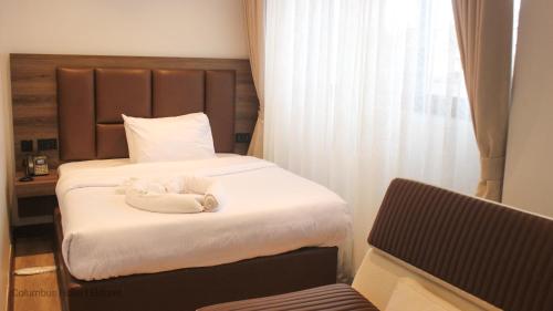 Ένα ή περισσότερα κρεβάτια σε δωμάτιο στο Columbus hotel