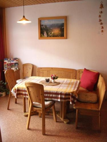a dining room table and chairs with a table and sidx sidx sidx at Fewo Benedikta in Beuron