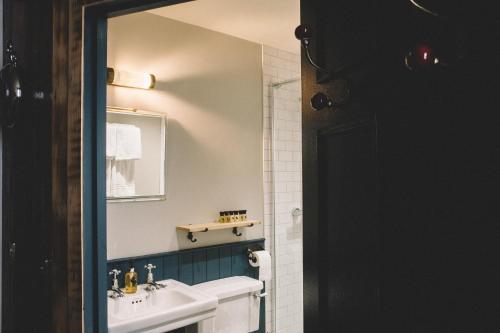 a bathroom with a sink and a mirror at The Stag at Stow in Stow on the Wold