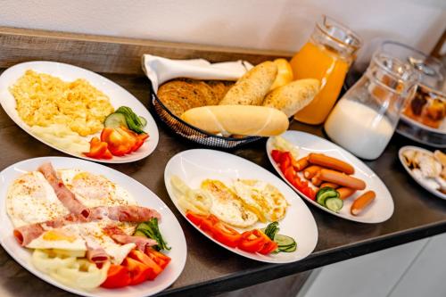 a table with plates of food on a table at Apartmány Vera in Bešeňová