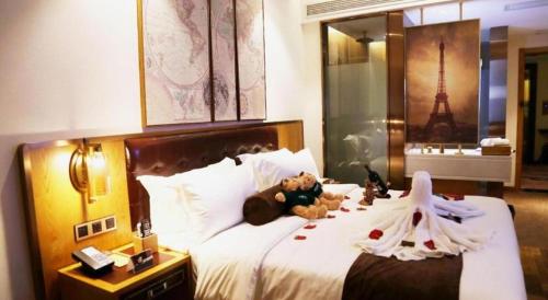 a bedroom with a bed with two teddy bears on it at James Joyce Coffetel· Hefei Anhui Agricultural University in Hefei