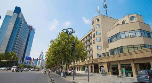 a tall building with a statue in front of it at James Joyce Coffetel· Hefei Anhui Agricultural University in Hefei