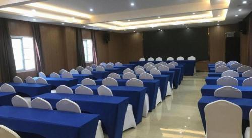 a large room with blue tables and white chairs at James Joyce Coffetel· Hefei Anhui Agricultural University in Hefei