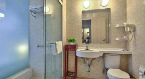 a bathroom with a sink and a toilet and a shower at Jinjiang Inn Style Xiangshan Bus Station in Xiangshan