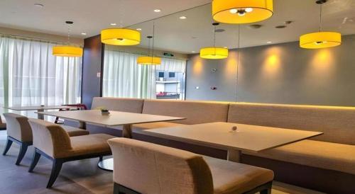a restaurant with two tables and chairs and yellow lights at Jinjiang Inn Style Xiangshan Bus Station in Xiangshan