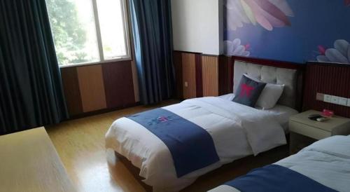 Ένα ή περισσότερα κρεβάτια σε δωμάτιο στο PAI Hotels·Zigong Rong County Dafosi South Bus Station