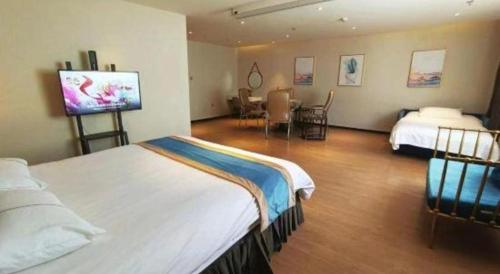a hotel room with two beds and a tv at Magnotel Shenyang Consulate Qingnian Street in Shenyang