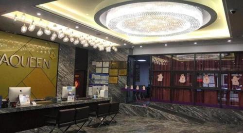 a cosmetics store with a counter and chairs in a room at Zhuhai Aqueen Hotel in Zhuhai