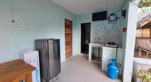 a kitchen with a stainless steel refrigerator in a room at Yemaya de Laiya powered by Cocotel in Batangas City