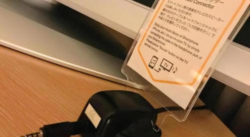 a piece of paper on top of a black phone at Yokohama Royal Park Hotel in Yokohama