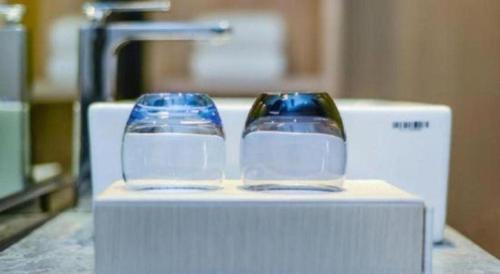 two glass vases sitting on top of a table at Ramada by Wyndham Zibo in Zibo