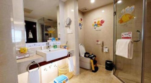 a bathroom with a sink and a shower at Ramada by Wyndham Zibo in Zibo