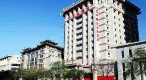 a large white building with red stripes on it at Ramada by Wyndham Xi'an Bell Tower in Xi'an