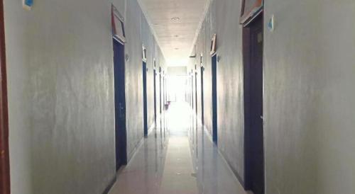 a hallway of a building with the light coming in at Hotel O Tri Homestay in Palangkaraya