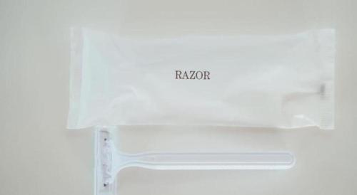 a white refrigerator with the word revision written on it at Hotel Areaone Miyazaki in Miyazaki