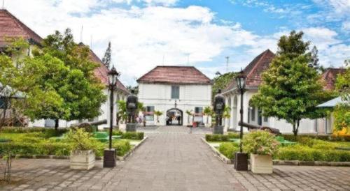 a street in a town with a white building at Super OYO 1788 House 24 in Yogyakarta