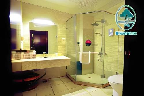 a bathroom with a shower and a sink and a toilet at GreenTree Inn Datong YundinGYAyuan Express Hotel in Datong
