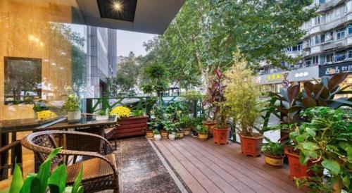 a balcony with a bunch of potted plants on it at Hangzhou Bokai Westlake Hotel in Hangzhou