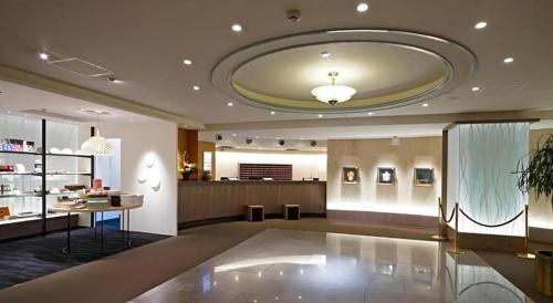 a large room with a large ceiling with a large table at Hotel Riverge Akebono in Fukui