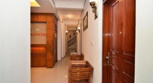 a hallway with wooden floors and a hallway with stairs at Havilla Maranatha in Padang